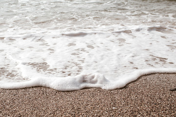 Waves crashing on rocks on  beach. Scenic seascape. Beautiful surf at seaside. Splashing waves with foam. Travel and vacation on shore. Rocky coastline. Nature power.