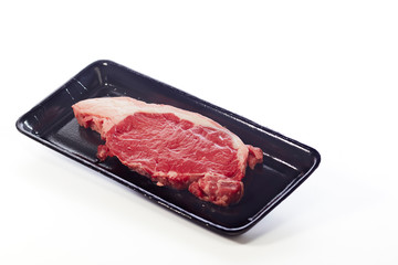 raw beef steak in  package on white