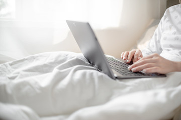 Work from home concept . Blonde Giirl typing and using laptop. Hygge Horizontal copyspace