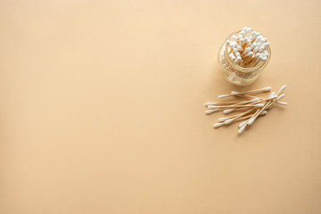 bamboo cotton buds on beige background, space for text