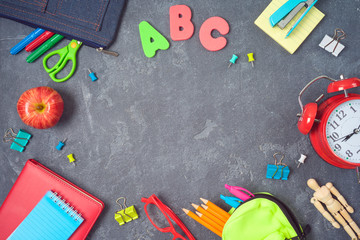 Back to school background with school supplies on blackboard. Top view from above