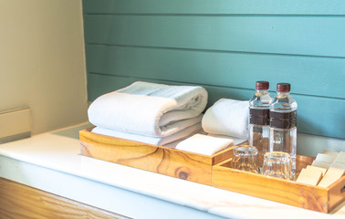 A set of hotel toiletries with white clean towel in a bathroom, copy space