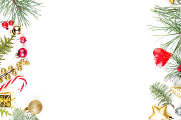 Christmas border made of green Xmas tree twig and New Year decoration on white background