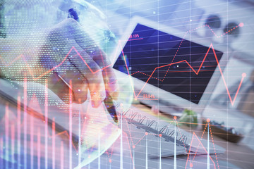 Financial forex graph drawn over hands taking notes background. Concept of research. Multi exposure