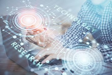 Businessman with computer background with technology theme hologram. Concept of hightech. Multi exposure.