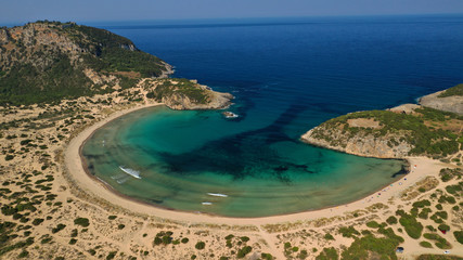 Fototapeta na wymiar Aerial drone view of semicircular sandy beach and lagoon of Voidokilia, one of the most iconic beaches in Mediterranean sea, with crystal clear turquoise sea, Messinia, Greece