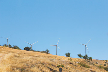 wind power plant windmill energy electricity on the yellow hills soft selective focus