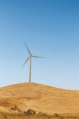 wind power plant windmill energy electricity on the yellow hills soft selective focus