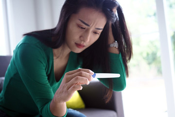 Asian beautiful women are stressed and worried about pregnancy results. Pregnancy beyond...