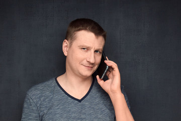 Portrait of contented and confident man speaking on phone