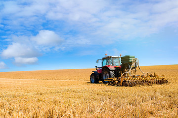 Fototapeta na wymiar farmer plowing fields after summer grain harvest