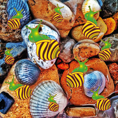 a group of painted snails on the background of multi-colored stones and shells