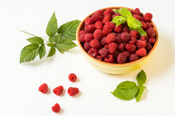 Red fresh ripe raspberry in a bowl. Summer concept.
