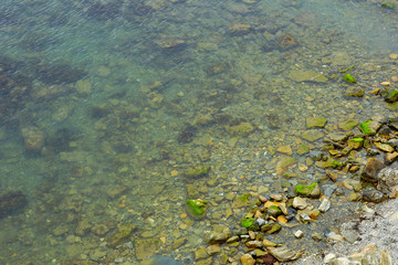 sea stones on the beach clear water. sea background top view