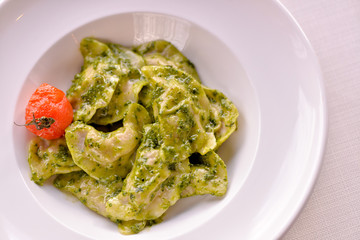 Dumplings are ready in a dish with green sauce