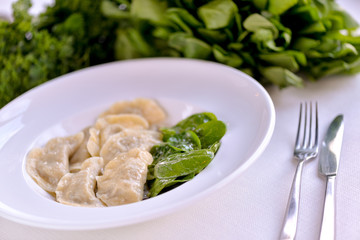 Dumplings made in a dish with spinach