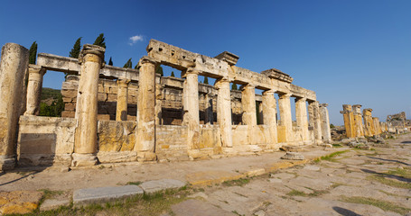 Fototapeta premium Turkey: the Latrine on Frontinus Street, main street to the Roman city of Hierapolis (Holy City), ancient city located on hot springs in classical Phrygia whose ruins are near Pamukkale