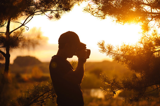 Man silhouette photographer and camera taking photo of sunset. Travel. Lifestyle hobby concept adventure active vacations outdoor.