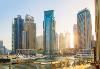 Dubai, UAE United Arabs Emirates. Dubai marina skyscrapers and yachts at sunset. Apartments, hotels...