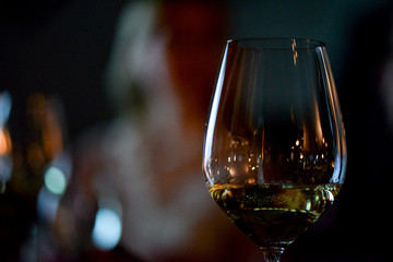 glass of brandy on background