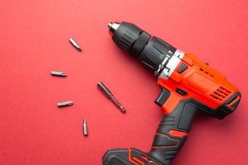 Battery drill on a red background