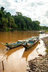 Naklejka na ściany i meble Canoes made of wood, standing on the banks of the Nam Khan river, Luang Prabang, Laos 