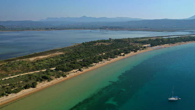 Aerial drone photo of iconic sandy beach of Divari (chrysi akti) with emerald sea near island of Sfaktiria in bay of Navarino, Messinia, Gialova, Peloponnese, Greece