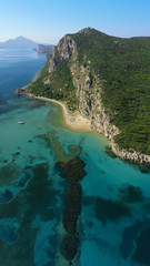 Aerial drone photo of iconic secluded sandy beach with emerald sea in island of Sfaktiria next to bay and famous beach of Divari (chrysi akti), Messinia, Gialova, Peloponnese, Greece