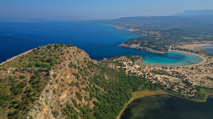 Naklejka na ściany i meble Aerial drone view of semicircular sandy beach and lagoon of Voidokilia, one of the most iconic beaches in Mediterranean sea, with crystal clear turquoise sea, Messinia, Greece