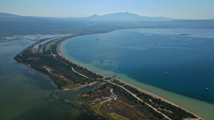 Aerial drone photo of iconic sandy beach of Divari (chrysi akti) with emerald sea near island of Sfaktiria in bay of Navarino, Messinia, Gialova, Peloponnese, Greece