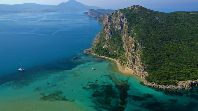 Aerial drone photo of iconic secluded sandy beach with emerald sea in island of Sfaktiria next to bay and famous beach of Divari (chrysi akti), Messinia, Gialova, Peloponnese, Greece