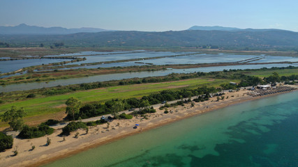 Aerial drone photo of iconic sandy beach of Divari (chrysi akti) with emerald sea near island of Sfaktiria in bay of Navarino, Messinia, Gialova, Peloponnese, Greece