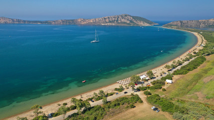 Aerial drone photo of iconic sandy beach of Divari (chrysi akti) with emerald sea near island of Sfaktiria in bay of Navarino, Messinia, Gialova, Peloponnese, Greece