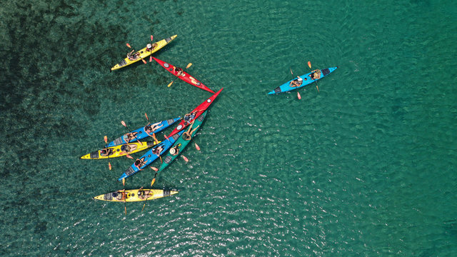 Aerial drone photo of colourful sport canoes operated by young athletes competing in Mediterranean bay with crystal clear turquoise sea © aerial-drone