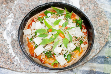  Vegetable pizza in the tray on the table