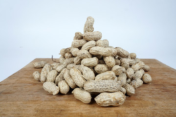 Fototapeta na wymiar peanuts in shell on wooden table