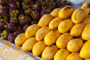 Yelow mango fruits and mangosteens
