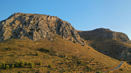 Aerial drone panoramic view of iconic uphill medieval castle of Acrocorinth an ancient citadel overlooking ancient Corinth, Peloponnese, Greece