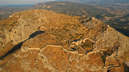 Aerial drone panoramic view of iconic uphill medieval castle of Acrocorinth an ancient citadel overlooking ancient Corinth, Peloponnese, Greece