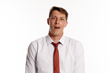 Portrait of a young brunet man posing in a studio isolated over a white background.