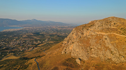 Aerial drone panoramic view of iconic uphill medieval castle of Acrocorinth an ancient citadel overlooking ancient Corinth, Peloponnese, Greece