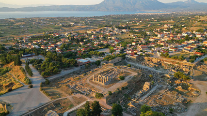 Aerial drone photo of iconic archaeological site of Ancient Corinth featuring temple of Apollo built in the slopes of Acrocorinth, Peloponnese, Greece