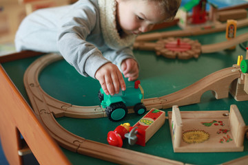 Boy playing with a toy tractor