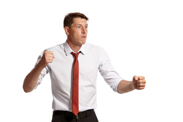 Portrait of a young brunet man posing in a studio isolated over a white background.