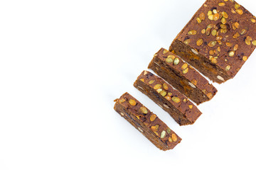 Bread with nuts and dried fruits, prunes, dried apricots, raisins and seeds on isolated white background