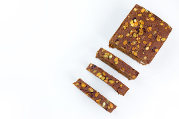Bread with nuts and dried fruits, prunes, dried apricots, raisins and seeds on isolated white background
