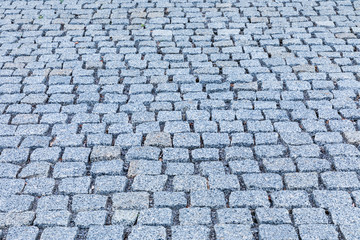 Fototapeta premium The gray pavement of square stones background or texture