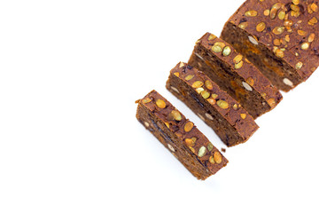 Bread with nuts and dried fruits, prunes, dried apricots, raisins and seeds on isolated white background
