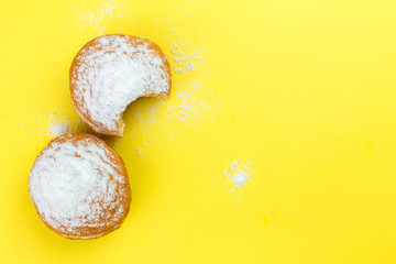 Donut with sugar isolated on yellow background. Top view