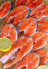 Red fish steak, freshly cut with peel on a cutting board